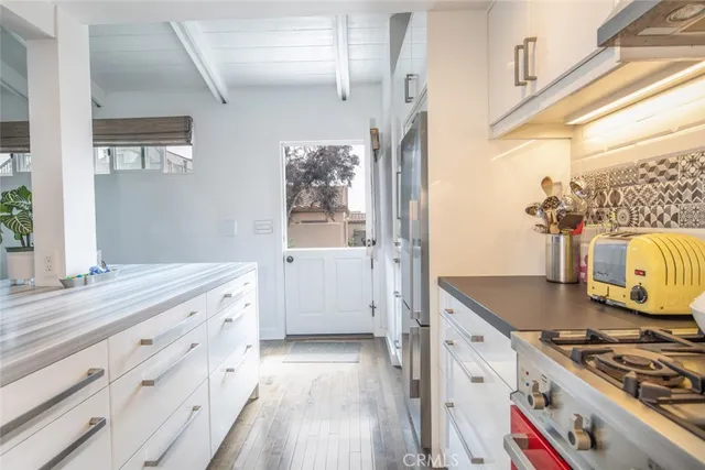 a kitchen with stainless steel appliances granite countertop a stove and a sink