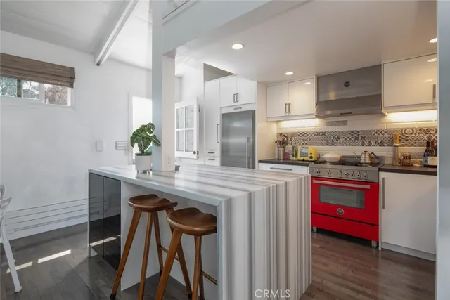 a kitchen with kitchen island a table and chairs in it
