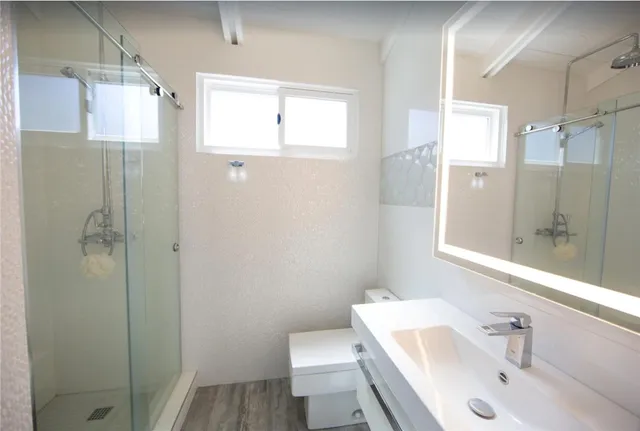 a bathroom with a sink toilet and shower