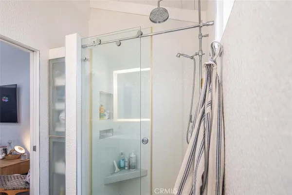 a bathroom with a shower and a glass door