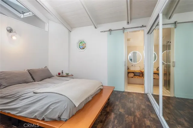 a bedroom with a bed and a mirror