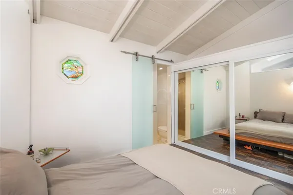 a bedroom with a bed and a shower
