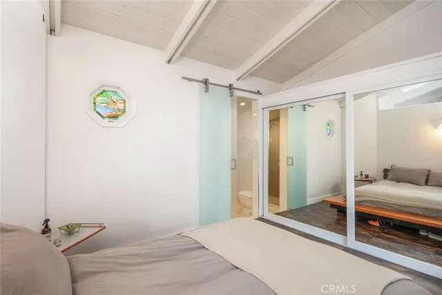 a bedroom with a bed and a shower