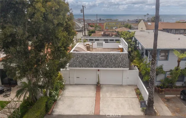 a white building with trees in front of it
