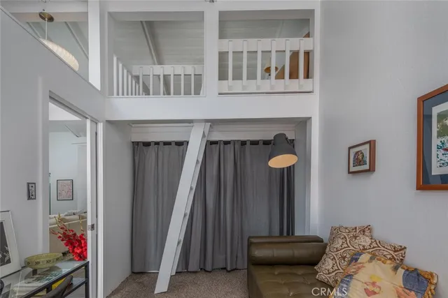 a view of a livingroom with furniture and staircase