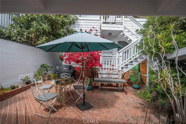 an outdoor space with furniture and umbrella