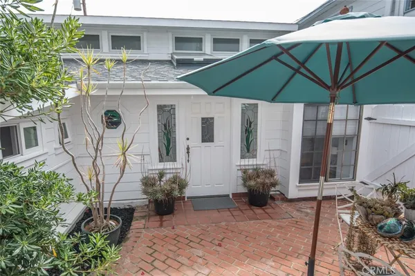 a view of a chair and table under an umbrella