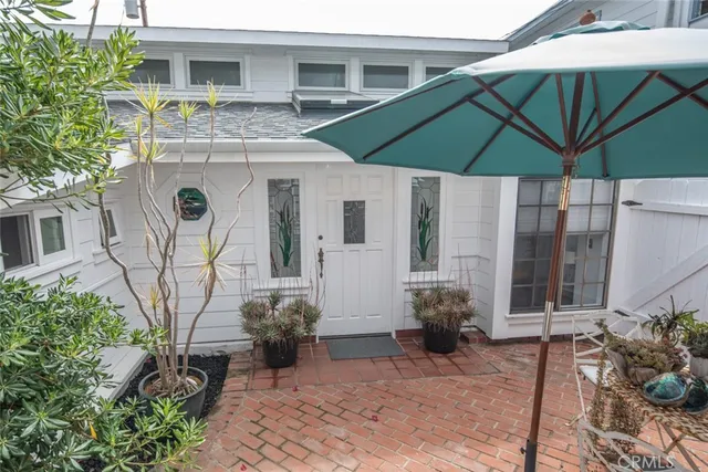 a view of a chair and table under an umbrella