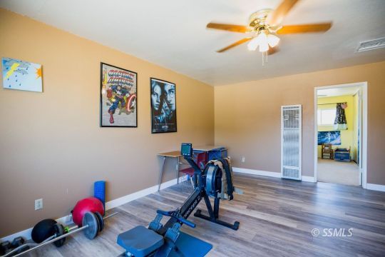 2030 South Inyo Street Ridgecrest, CA 93555 - Photo 31 of 42 a view of a workspace with furniture and wooden floor