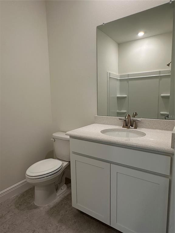 6107 Southwest 115th Street Road Ocala, FL 34476 - Photo 11 of 16 a bathroom with a granite countertop toilet sink and mirror