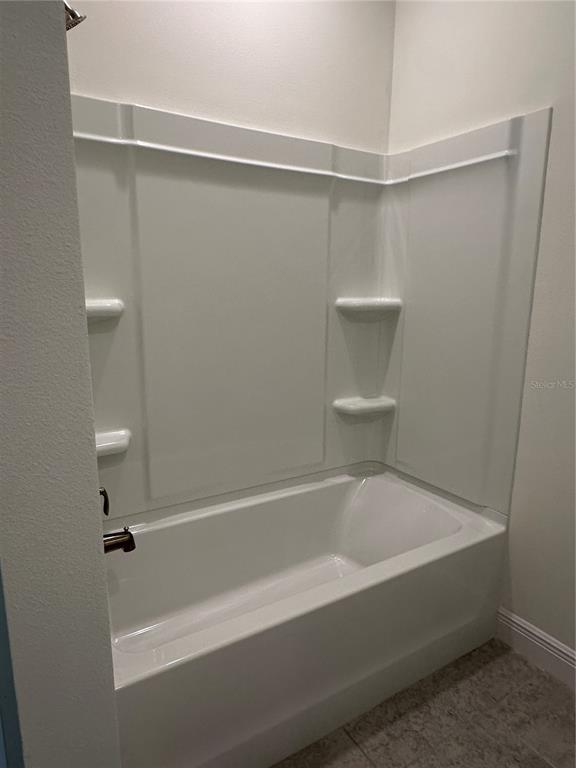 6107 Southwest 115th Street Road Ocala, FL 34476 - Photo 12 of 16 a bathroom with a bathtub and a shower