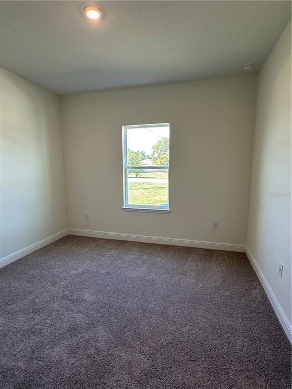 6107 Southwest 115th Street Road Ocala, FL 34476 - Photo 14 of 16 an empty room with a window