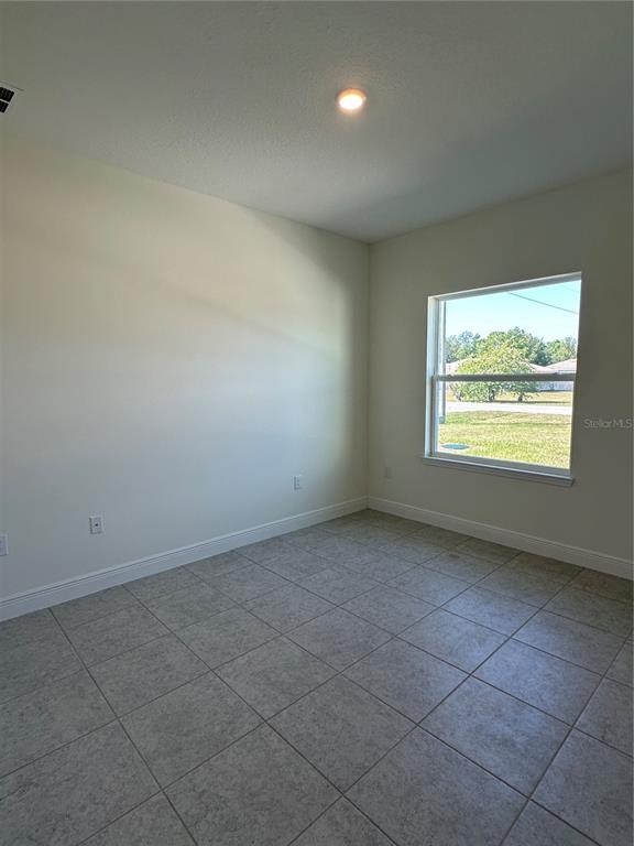 6107 Southwest 115th Street Road Ocala, FL 34476 - Photo 15 of 16 an empty room with windows