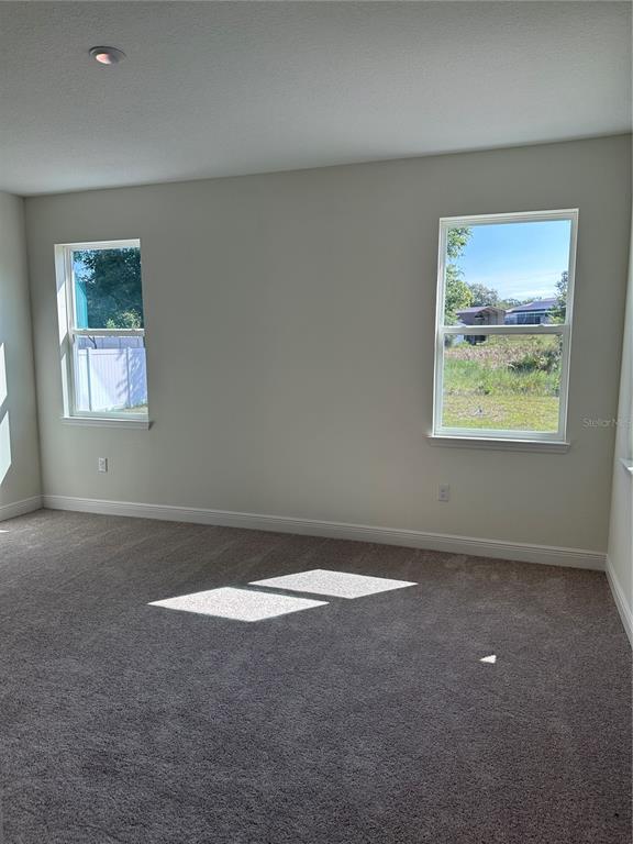 6107 Southwest 115th Street Road Ocala, FL 34476 - Photo 4 of 16 a view of an empty room with a window