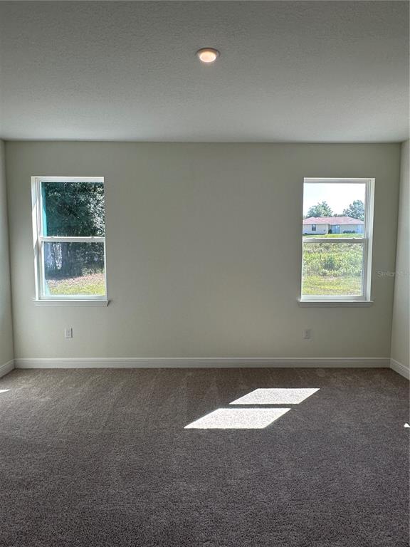 6107 Southwest 115th Street Road Ocala, FL 34476 - Photo 10 of 16 an empty room with a empty space and window