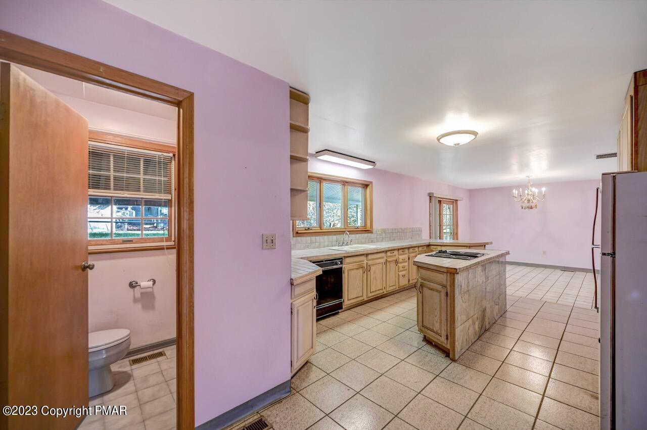 145 Gap View Circle Bushkill, PA 18324 - Photo 12 of 37 a kitchen with granite countertop a stove a sink and a refrigerator