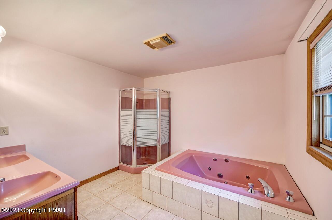 145 Gap View Circle Bushkill, PA 18324 - Photo 24 of 37 a bathroom with a bath tub sitting next to a window