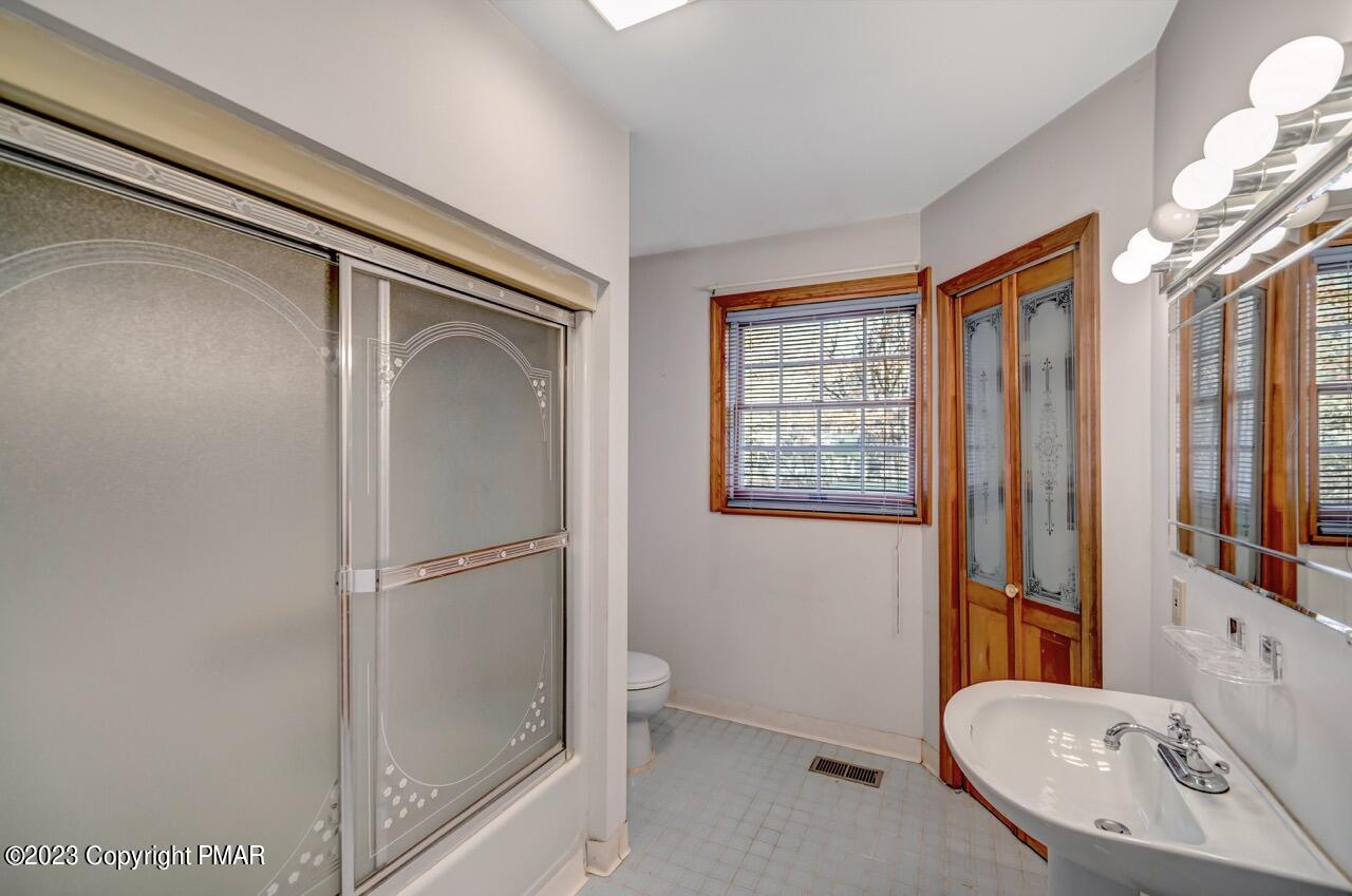 145 Gap View Circle Bushkill, PA 18324 - Photo 29 of 37 a bathroom with a sink a mirror and a shower