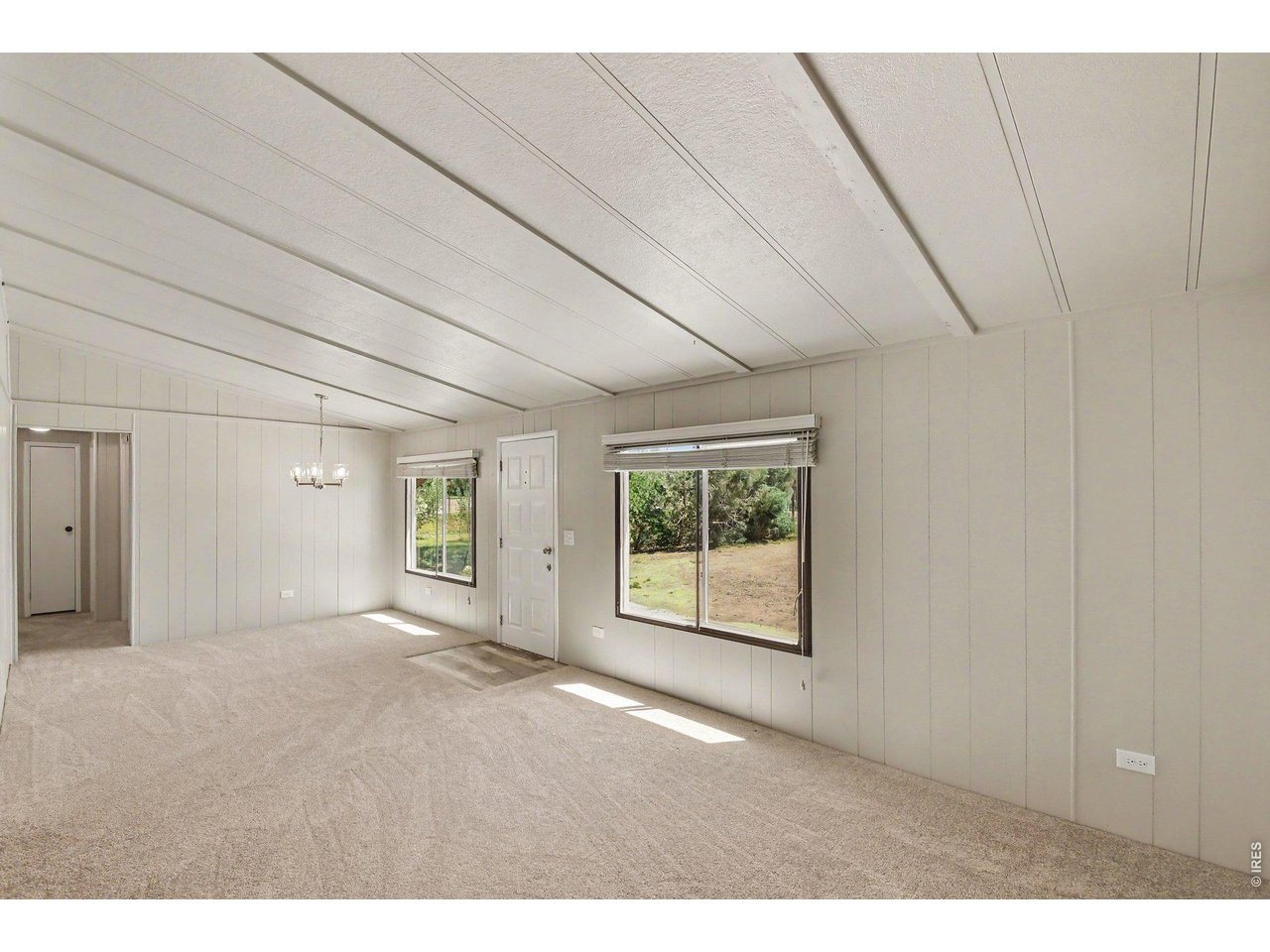 8317 6th Street Wellington, CO 80549 - Photo 3 of 21 Bright, oversized living space with fresh paint and new carpet