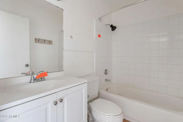 a bathroom with a sink vanity mirror and toilet