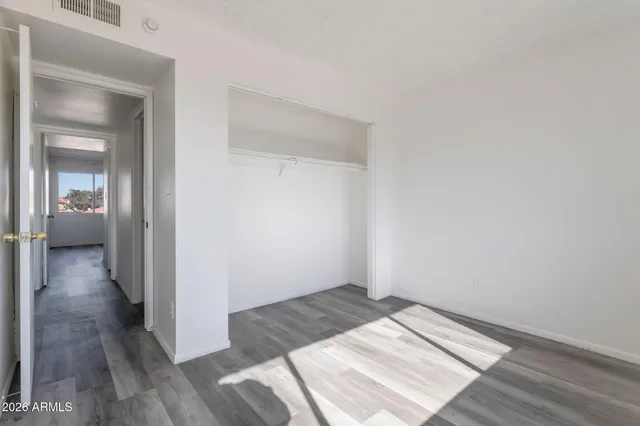 a view of a bedroom with wooden floor