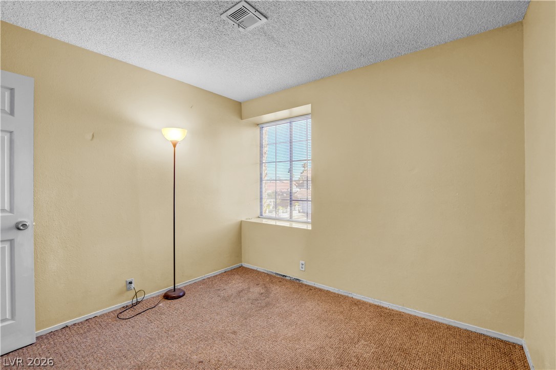 6440 Hartwood Road Las Vegas, NV 89108 - Photo 49 of 59 A well-lit room with carpeted flooring and a window offering natural illumination.