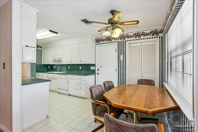 a dining room with a table chairs and entryway