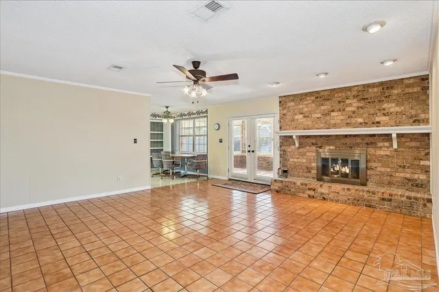 an empty room with fireplace and windows