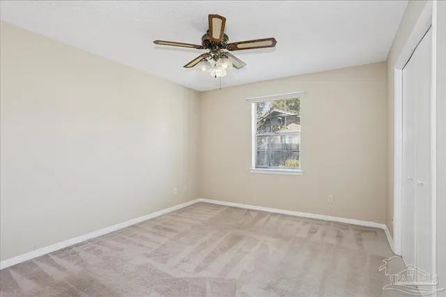 a view of room with window and ceiling fan