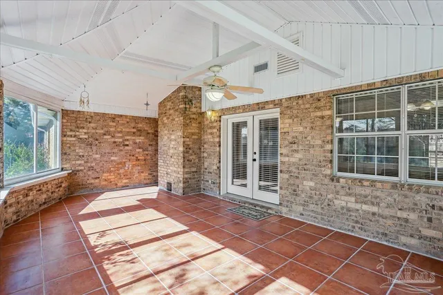 a view of a porch with wooden floor and fence