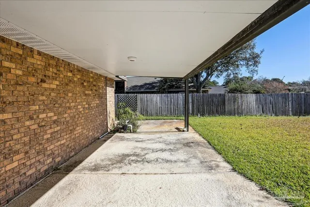 a view of a backyard with a fence