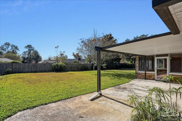 a view of a swimming pool with a yard