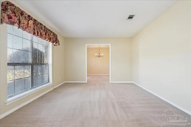 a view of an empty room with a window