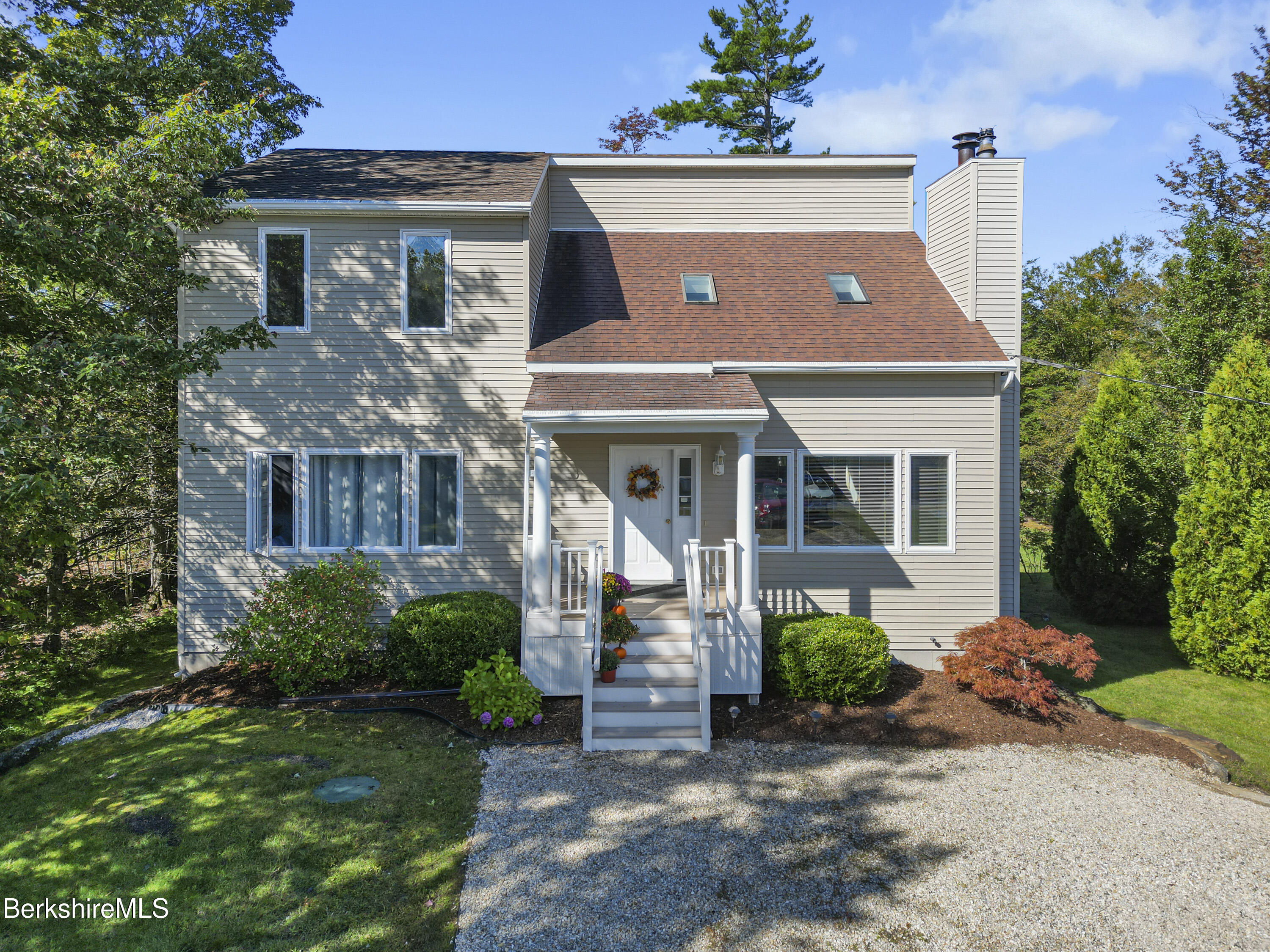 a front view of a house with garden