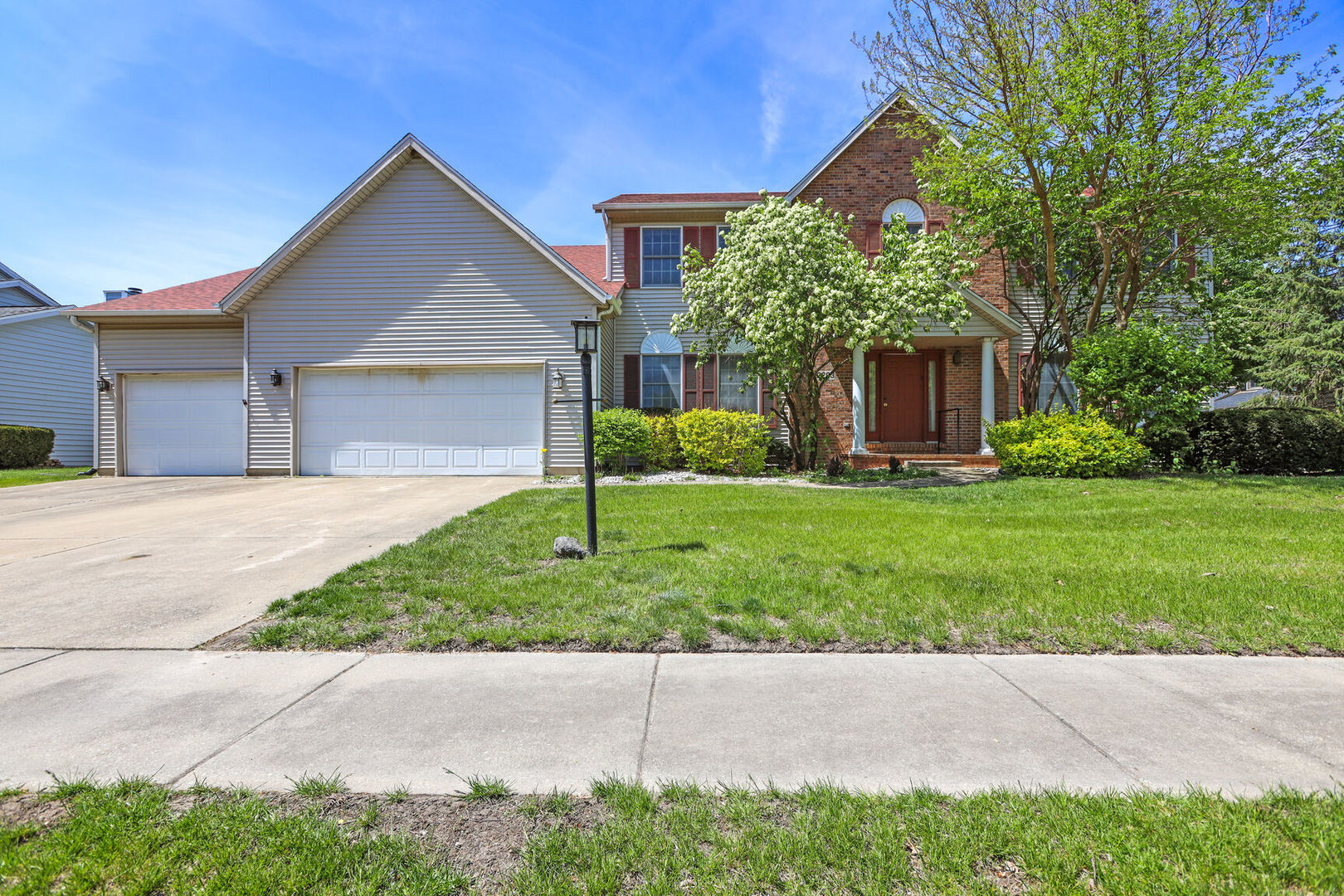 a front view of house with yard and green space