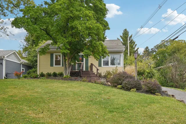 a front view of a house with a garden