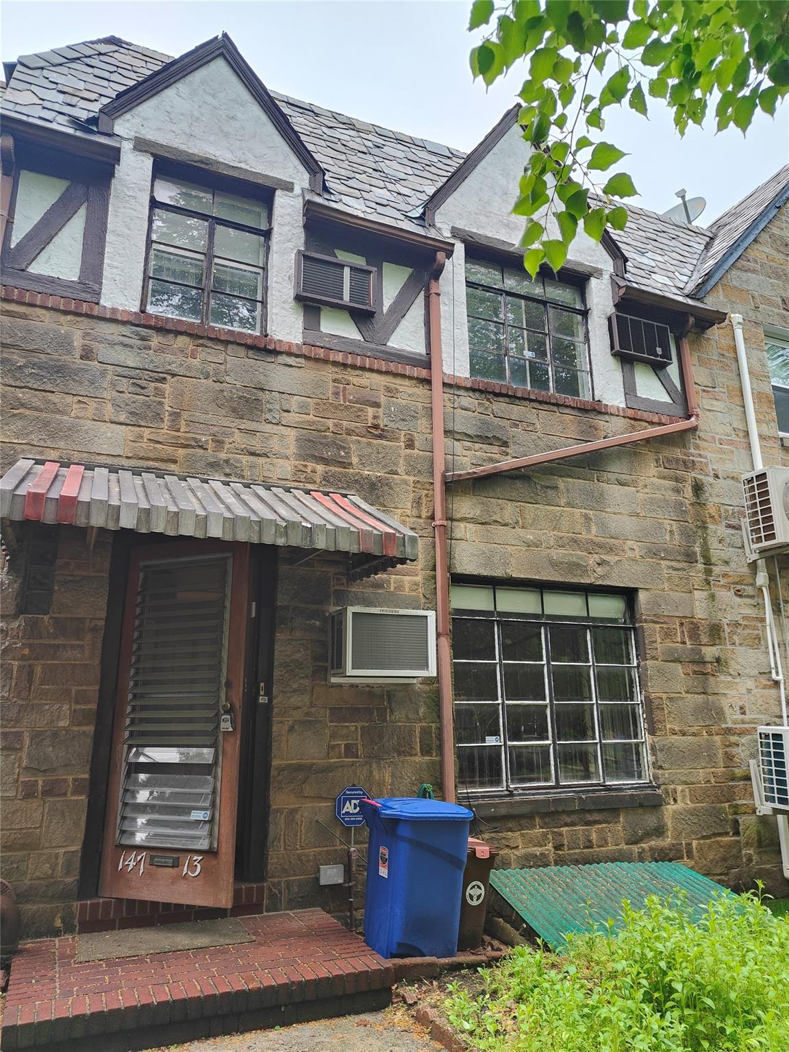 147-13 72nd Drive Queens, NY 11367 - Photo 1 of 1 Back of house featuring a high end roof, ac unit, and stone siding