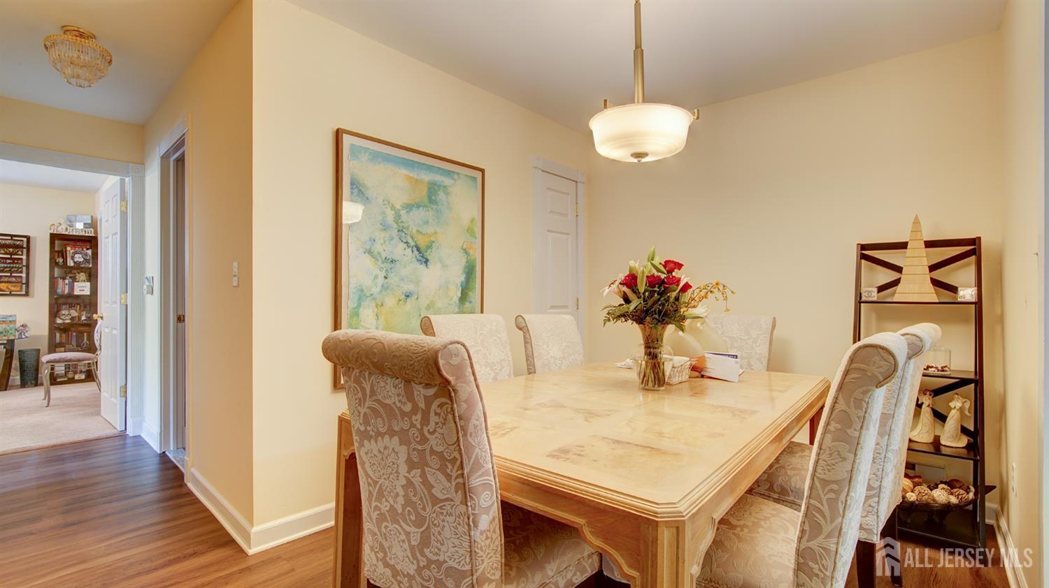 86 Arrowood Road, Unit G Manalapan, NJ 07726 - Photo 4 of 16 a dining room with furniture and wooden floor