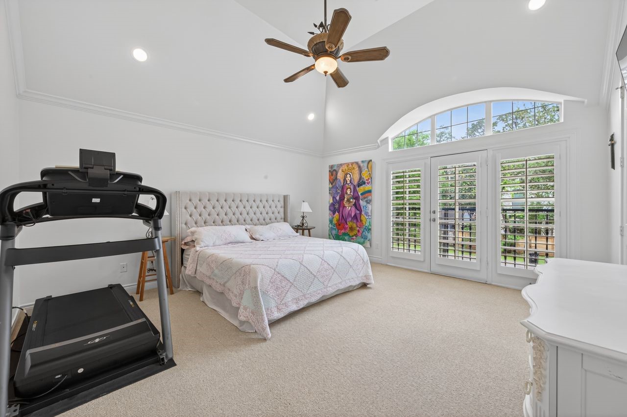 10932 Lasso Lane Houston, TX 77079 - Photo 16 of 38 a spacious bedroom with a bed and a large window