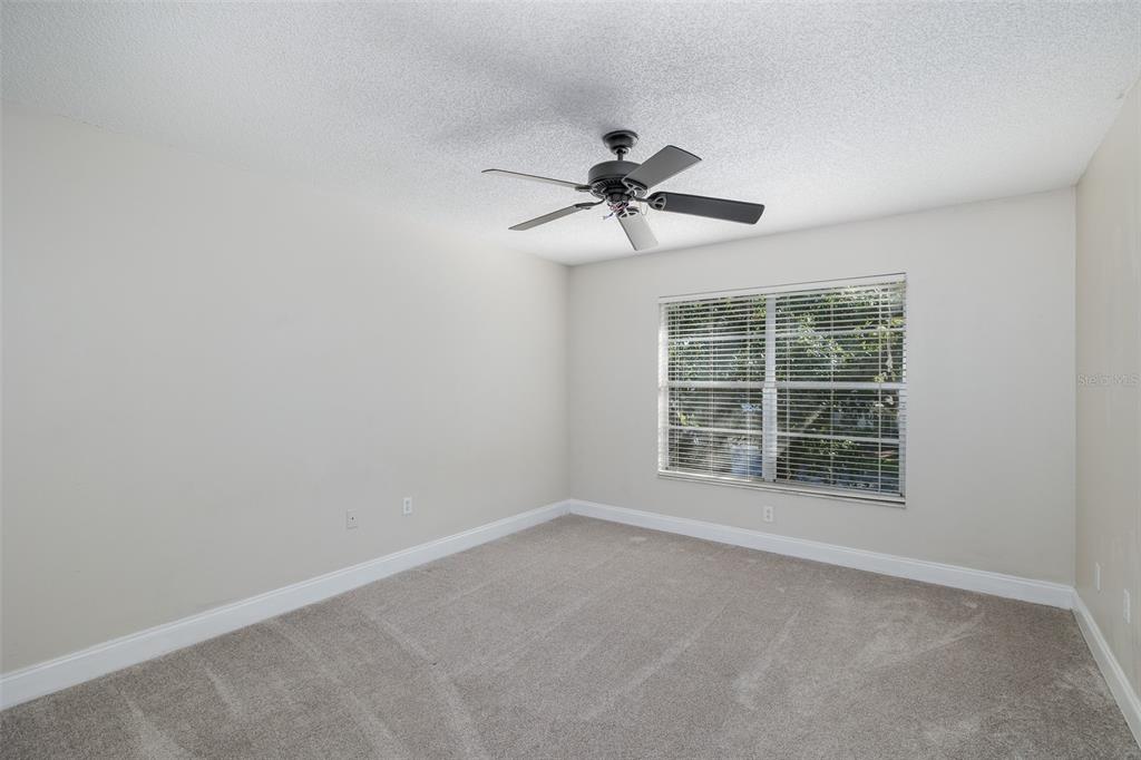 7900 Hardwick Drive, Unit 827 New Port Richey, FL 34653 - Photo 19 of 27 a view of room with a ceiling fan and a window