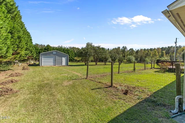 a view of swimming pool with lawn chairs and potted plants
