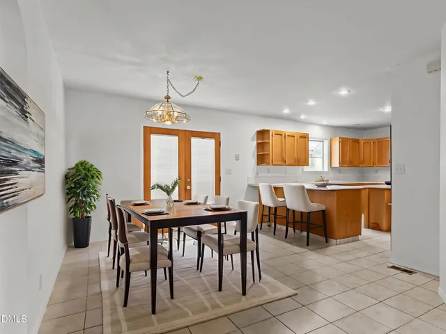 a kitchen with stainless steel appliances granite countertop a sink a stove a refrigerator a washer dryer and a cabinets