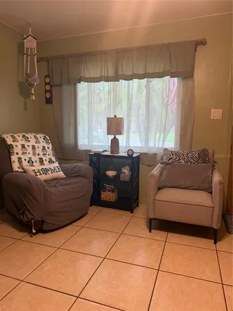 a living room with furniture and a large window