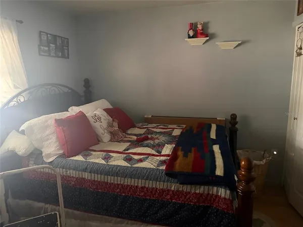 a bedroom with a bed and a window