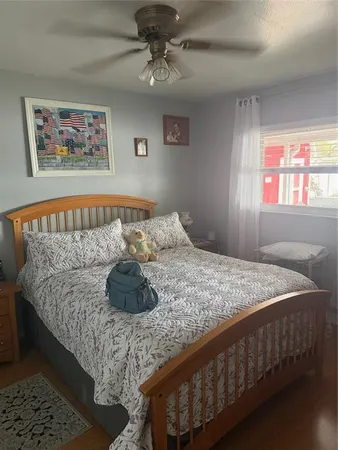 a bed sitting in a bedroom next to a window