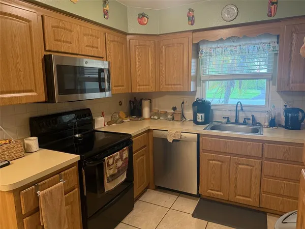 a kitchen with a sink stove and microwave