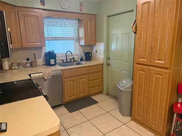 a kitchen with a sink a stove and cabinets