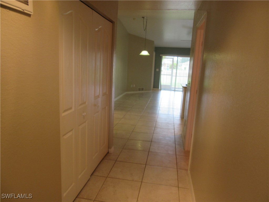 271 Southwest 4th Street, Unit 271 Cape Coral, FL 33991 - Photo 2 of 17 a view of hallway with a window