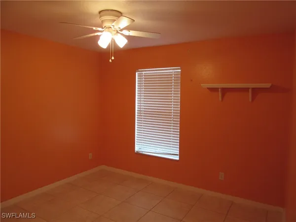 a view of a room with a ceiling fan and a window