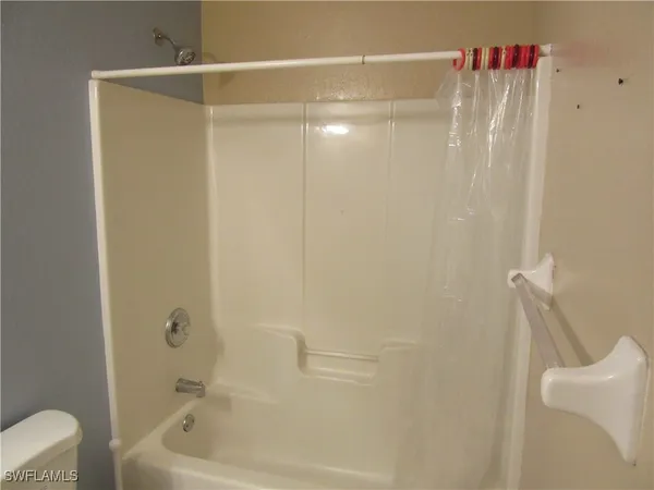 a bathroom with a shower and a tub